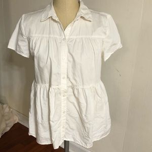 Women’s white short sleeve button up shirt.
